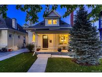 Charming home featuring a covered front porch, manicured lawn, and classic architectural details, perfect for curb appeal at 340 S Logan St, Denver, CO 80209