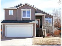 Charming two-story home featuring a well-maintained yard and attached two-car garage at 16952 Dandelion Way, Parker, CO 80134