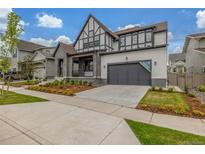 Stunning two-story home featuring a gray facade, well-manicured lawn, and an attached two-car garage at 1846 Chestnut Ave, Erie, CO 80516