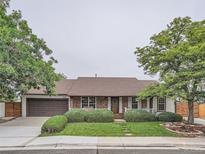 Charming single-story home with brick accents, manicured lawn, mature trees, and attached two-car garage at 3265 W 11Th Avenue Ct, Broomfield, CO 80020