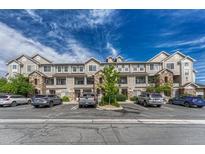 Attractive condominium building with stone accents, balconies, and ample parking on a sunny day at 12711 Colorado Blvd # 714G, Thornton, CO 80241