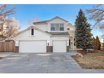 Charming two-story home featuring a three car garage, covered porch, and well-maintained landscaping at 8369 W Fairview Ave, Littleton, CO 80128