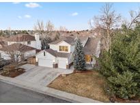 Charming two-story home featuring a three-car garage and well-maintained landscaping with mature trees at 8369 W Fairview Ave, Littleton, CO 80128