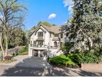 Stately two-story home boasts a two-car garage, classic architectural style, and professionally landscaped yard at 1991 E Alameda Ave # 14, Denver, CO 80209