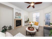 Inviting living room featuring a cozy fireplace, neutral tones, and stylish decor at 3100 Blue Sky Cir # 205, Erie, CO 80516