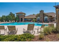 Beautiful community pool with lounge chairs and seating area perfect for relaxing and enjoying the summer weather at 3100 Blue Sky Cir # 205, Erie, CO 80516