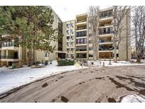 Apartment building exterior with snow-covered landscaping at 13890 E Marina Dr # 107, Aurora, CO 80014