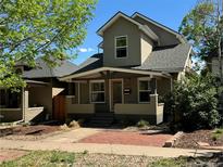 Charming two-story home with a covered porch, landscaped front yard, and inviting curb appeal at 3440 W 33Rd Ave, Denver, CO 80211