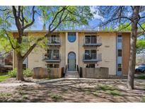Two-story apartment building featuring four balconies, neutral paint, and a well-kept lawn at 12108 Melody Dr # 103, Denver, CO 80234