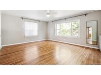 Bright bedroom with hardwood floors, updated windows, and ceiling fan fixture at 1416 N Downing St # 1, Denver, CO 80218