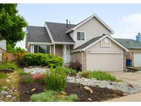 Inviting two-story home with well-kept landscaping, a two-car garage, and beautiful curb appeal at 4127 S Lewiston Cir, Aurora, CO 80013
