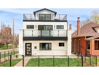 Modern three-story home featuring multi-level balconies and a sleek black metal fence at 1757 W 36Th Ave, Denver, CO 80211