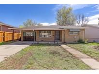 Charming single-story home with brick facade, covered porch, and a partially xeriscaped front lawn at 256 King St, Denver, CO 80219