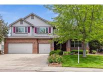 Charming two-story home with a brick facade, three-car garage and manicured lawn at 10440 Lowell Ct, Westminster, CO 80031