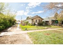 Charming single story home with a well maintained front yard and cozy curb appeal at 2235 Eaton St, Edgewater, CO 80214