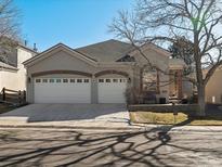 Charming home featuring stucco siding, brick accents, two-car garage, and well-maintained landscaping at 6700 W Dorado Dr # 42, Littleton, CO 80123