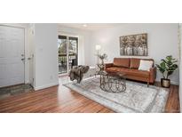 Bright living room with wood floors, balcony access, and stylish decor at 5300 E Cherry Creek South Dr # 1327, Denver, CO 80246