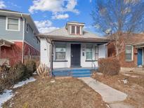 Charming bungalow-style home with a white brick facade and inviting blue porch steps at 805 S Lincoln St, Denver, CO 80209