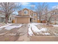 Charming two-story home with a two-car garage, a brick facade, and a landscaped yard in a desirable neighborhood at 5541 S Youngfield St, Littleton, CO 80127