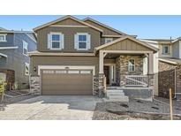 Beautiful two-story home featuring stone accents, a covered front porch, and a two-car garage at 28624 E 7Th Ave, Watkins, CO 80137