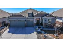 Charming single-Gathering home featuring a three-car garage and stone accents at 21916 E Swallow Pl, Aurora, CO 80016