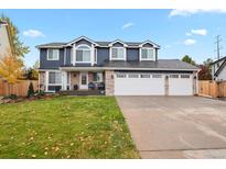 Charming two-story home features a three-car garage, well-manicured lawn, and inviting brick accents at 7404 La Quinta Ln, Lone Tree, CO 80124