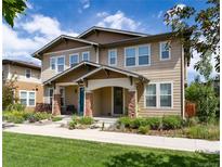 Charming two-story home featuring a well-maintained lawn and beautifully landscaped front yard at 3412 Valentia St, Denver, CO 80238