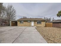 Charming brick home with a spacious driveway and well-maintained front yard, creating excellent curb appeal at 3771 S Federal Blvd, Englewood, CO 80110