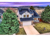 Charming two-story home with a two car garage and energy-efficient solar panels on the roof at 4735 Bobolink Dr, Castle Rock, CO 80109