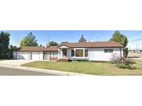 Charming single-story home with a well-maintained front yard and an attached two car garage at 609 S 1St Ave, Brighton, CO 80601