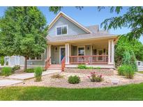 Charming home with a welcoming front porch, landscaped garden, and a well-maintained lawn at 3525 Rinn Valley Dr, Longmont, CO 80504