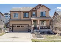 Charming two-story home with a covered front porch, stone accents, and a two-car garage at 3472 Harvard Pl, Broomfield, CO 80023