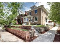 Charming brick two-story home with landscaped front yard and inviting entryway at 2 N Pennsylvania St, Denver, CO 80203