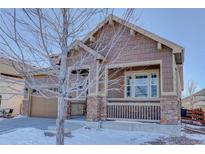 Two-story home with stone accents and a covered porch at 4967 S Ukraine St, Aurora, CO 80015