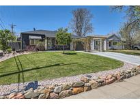 Charming home featuring a well-maintained lawn and decorative rock wall in a lovely neighborhood at 1701 Kingston St, Aurora, CO 80010