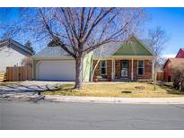 Charming front exterior with a well-kept lawn, mature trees, and a welcoming entrance with a bench at 19930 E Cornell Ave, Aurora, CO 80013