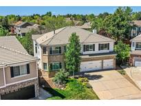 Beautiful two-story brick home featuring a three-car garage and well-manicured landscaping at 2950 Wyecliff Ln, Highlands Ranch, CO 80126