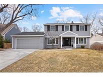 Charming two-story home with an attached garage, a well-maintained lawn, and a classic architectural design at 6869 S Niagara Ct, Centennial, CO 80112