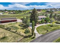 Sprawling property featuring home, large barn, mature trees and landscaping, fenced yard and circular driveway at 6646 S Fundy Ct, Centennial, CO 80016