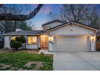 Charming home featuring a well-manicured lawn, attached two car garage, and beautiful exterior paint at 14867 E Pacific Pl, Aurora, CO 80014