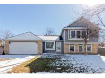 Charming two-story home with brick and gray siding and attached two car garage at 19454 E Florida Pl, Aurora, CO 80017