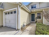 Charming townhome with a white garage door and green front door at 7822 South Kittredge Circle, Englewood, CO 80112