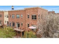 Beautiful brick building featuring balconies and a partial view of the water tower at 5428 Zephyr Ct, Arvada, CO 80002