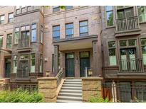 Charming multi-story brick condo with steps leading to a covered entryway, and decorative railings at 2950 E 17Th Ave, Denver, CO 80206