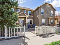 Charming two-story home featuring a welcoming front porch and a manicured front yard with a white picket fence at 3893 Ute Mountain Trl, Castle Rock, CO 80109