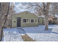 Charming single-story home featuring light-green siding and a snow-covered front yard at 1700 W Stoll Pl, Denver, CO 80221