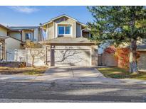 Two-story house with attached garage and landscaped yard at 2067 E Phillips Pl, Centennial, CO 80122