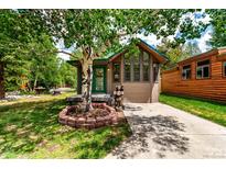 Charming exterior of this cozy home, featuring inviting curb appeal and a beautiful mature birch tree in the front yard at 85 Revett Dr # 15, Breckenridge, CO 80424