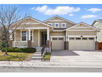 Charming exterior of home with a porch, well-maintained lawn, and two car garage at 6013 Eldora St, Golden, CO 80403