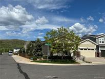 Charming corner lot home with well-maintained landscaping and a welcoming facade on a sunny day at 6013 Eldora St, Golden, CO 80403